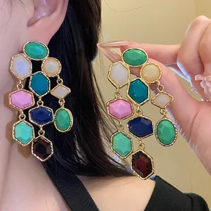 Detailed view of colorful vintage resin tassel earrings with elegant gold-tone settings