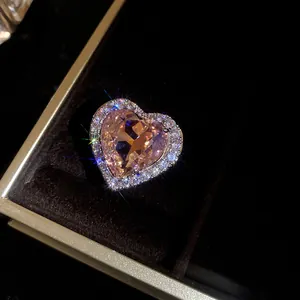 Macro view of a luxury pink heart-shaped zircon ring with sparkling diamond-set halo