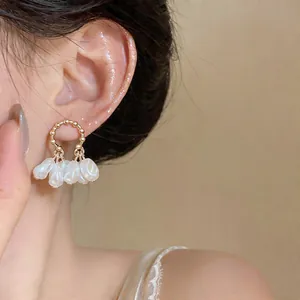 Detailed view of elegant French style gold hoop earrings with cluster pearl beads