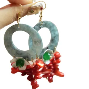 Vibrant bohemian style drop earrings with blue marble hoops and red coral tassels