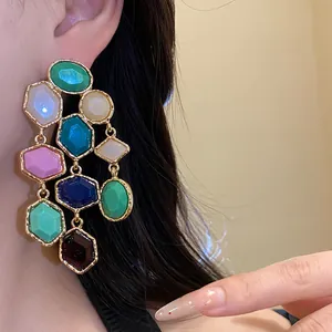 Detailed close-up of colorful resin vintage-style earrings worn on ear