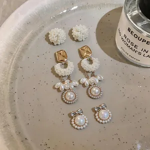 Detailed view of elegant French style pearl earring set with bow-knot and cluster designs