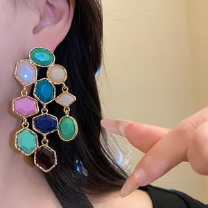 Detailed close-up showing vintage resin tassel earrings with colorful geometric shapes worn on ear