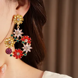 Detailed close-up of vintage colorful floral rhinestone wreath earrings worn on ear model