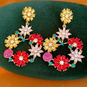 Detailed close-up of vintage-style gold earrings featuring colorful crystal flower patterns