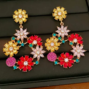 Close-up view of colorful vintage floral rhinestone drop earrings on black jewelry tray