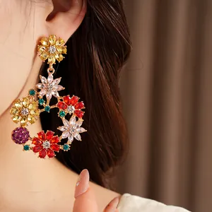 Close-up detail of luxurious vintage colorful crystal flower wreath earrings on a model