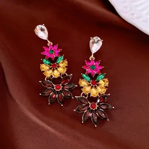 Vintage style floral drop earrings with multi-colored crystals on brown silk background
