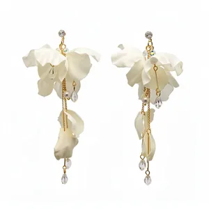 Elegant white fabric flower tassel earrings with pearls and crystals on white background