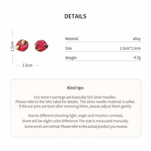 Detail view of asymmetric red heart earrings with material and size technical specifications.