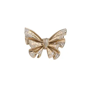 Elegant vintage gold butterfly brooch with shimmering crystal accents
