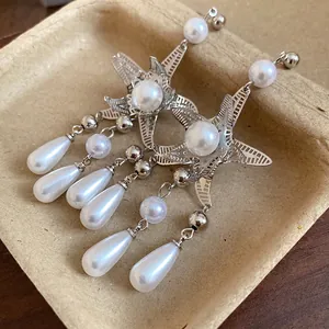 Eleganti orecchini a stella marina di lusso con nappe di perle e ago in argento