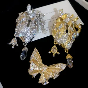 Detailed view of ornate vintage heart and butterfly brooches with sparkling rhinestones