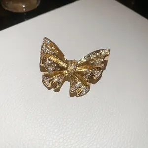 Close-up view of a luxury gold-toned butterfly brooch with sparkling crystals