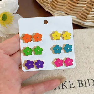 Detailed view of colorful camellia stud earrings in six vibrant dopamine shades