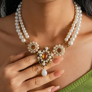 Close-up of vintage royal style double-layered pearl necklace with floral pendant