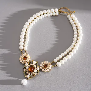 Detail of vintage palace style double-layer resin pearl necklace with flower charms