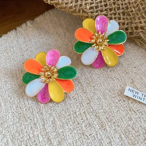 Detail of colorful oil-drop flower stud earrings with vibrant multi-colored petals