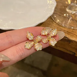 Close-up of elegant gold-plated glass flower stud earrings with S925 silver needles