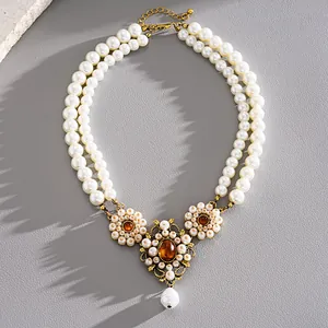 Close-up of vintage court style double-layer pearl necklace with floral accents
