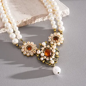 Close-up of vintage palace style double-layer resin pearl necklace with floral motifs