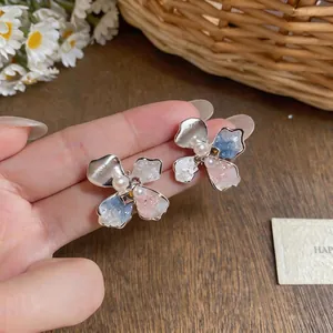 Elegant silver needle flower stud earrings featuring pearls and colorful petals