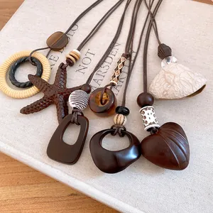 Detailed view of bohemian style necklaces with wood beads and resin pendants