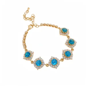 Bracelet floral doré élégant avec des pierres de zircone cubique bleues et blanches