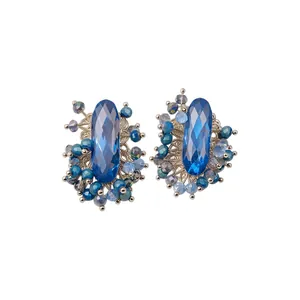 Vintage French style stud earrings featuring blue faceted gemstones and clusters of beads
