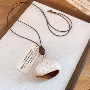 Macro view of vintage resin wood bead pendant with rustic texture on leather cord