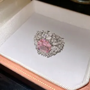 Elegant silver-tone open ring featuring a large pink cushion-cut zirconia centerpiece
