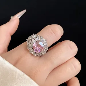 Elegant pink zircon cocktail ring surrounded by clear stones on a silver-tone band.