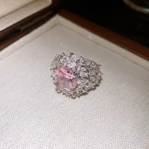 Macro view of a luxurious pink zircon ring with sparkling diamond-like halo stones.