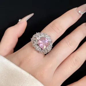 Macro detail of a luxury open ring featuring a pink square zircon and crystal halo