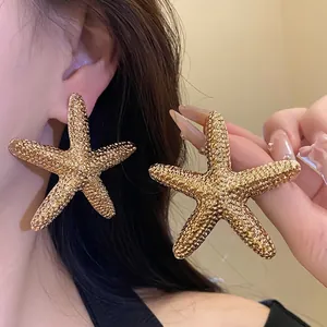 Elegant oversized gold starfish stud earrings with a vintage textured finish for summer