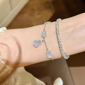 Close-up view of elegant silver gourd charm bracelet with zircon tennis chain
