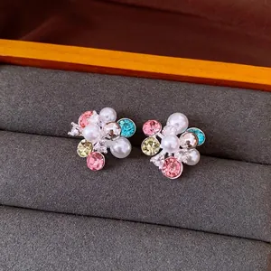 Floral cluster stud earrings with pearls and colorful crystals in a luxury display box
