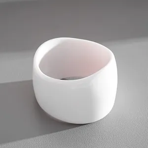 Detailed view of a white chunky resin geometric bangle on a textured gray background