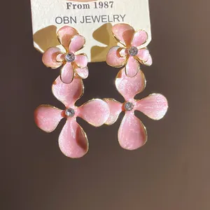 Detailed view showing the glittering pink enamel petals and sparkling central crystal
