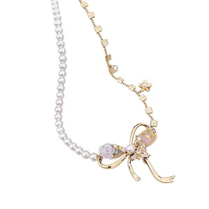 Elegant vintage pearl and gold chain necklace with intricate zircon bow and rose pendant