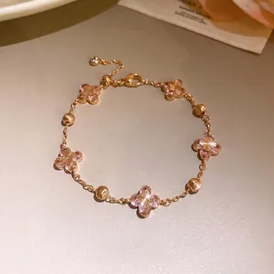Elegant rose gold bracelet with pink zircon flower charms and adjustable link chain