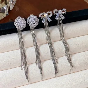 Elegant zircon bow and flower tassel drop earrings with silver needle on display