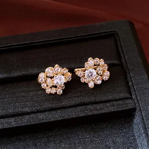 Elegant gold-tone round clip-on earrings with sparkling brilliant zircon clusters