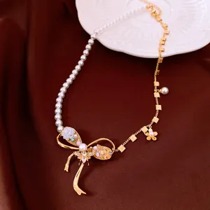 Detailed view of a vintage pearl bow necklace featuring elegant zircon flower charms