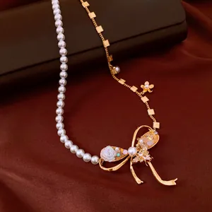 Detailed view of a vintage bow necklace with pearls and zircon embellishments