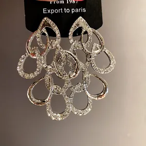 Stunning silver-tone chandelier earrings featuring intricate teardrop crystal clusters