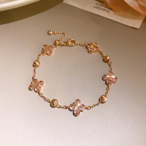 Detailed view of elegant rose gold bracelet with pink zircon flower charms