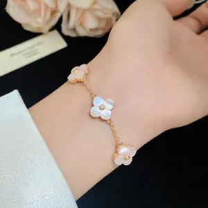 Detailed view of an elegant pink mother-of-pearl flower bracelet with zircon stone.