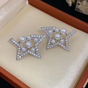 Elegant star-shaped silver needle stud earrings with white pearls and sparkling zircons