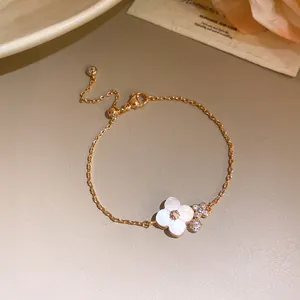 Elegant rose gold cherry blossom bracelet with pink shell petals and sparkling zircon stones.